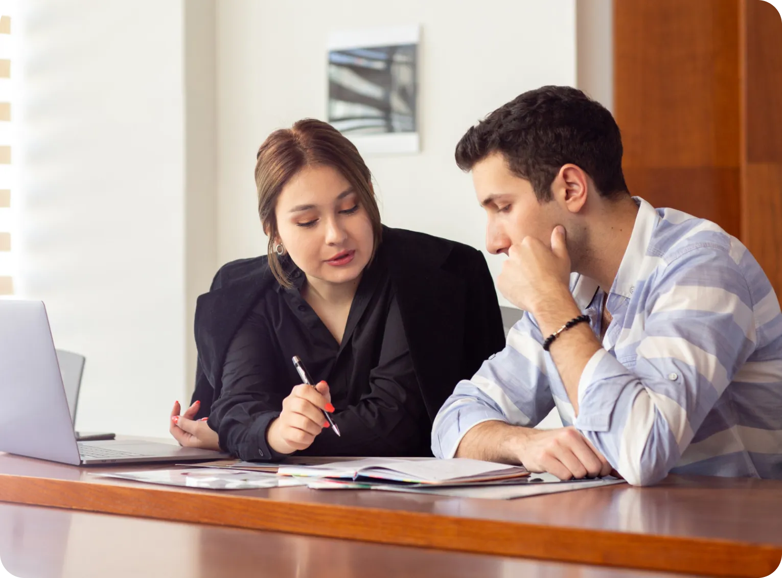 Research guide and doctoral scholar reviewing a research proposal